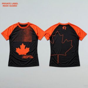 Black and orange Canada-inspired sublimated rash guard with maple leaf design shown in front and back view for BJJ, MMA, and No-Gi training